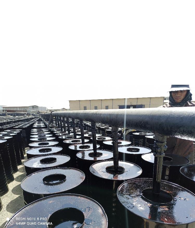 Steel drums being filled with bitumen on an export filling line in the UAE